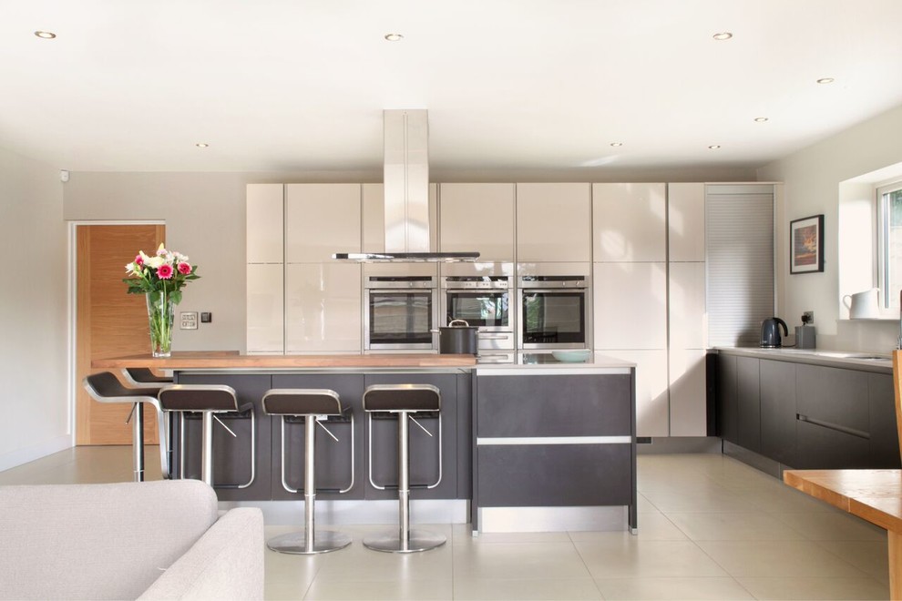 High gloss cashmere & black kitchen with large island Contemporary