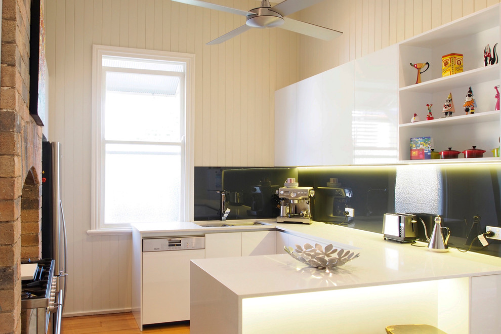 Contemporary enclosed kitchen in Brisbane with flat-panel cabinets and white cabinets.