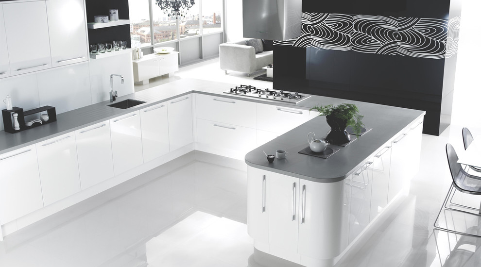 Design ideas for a contemporary kitchen in Hampshire with flat-panel cabinets, white cabinets and wood worktops.