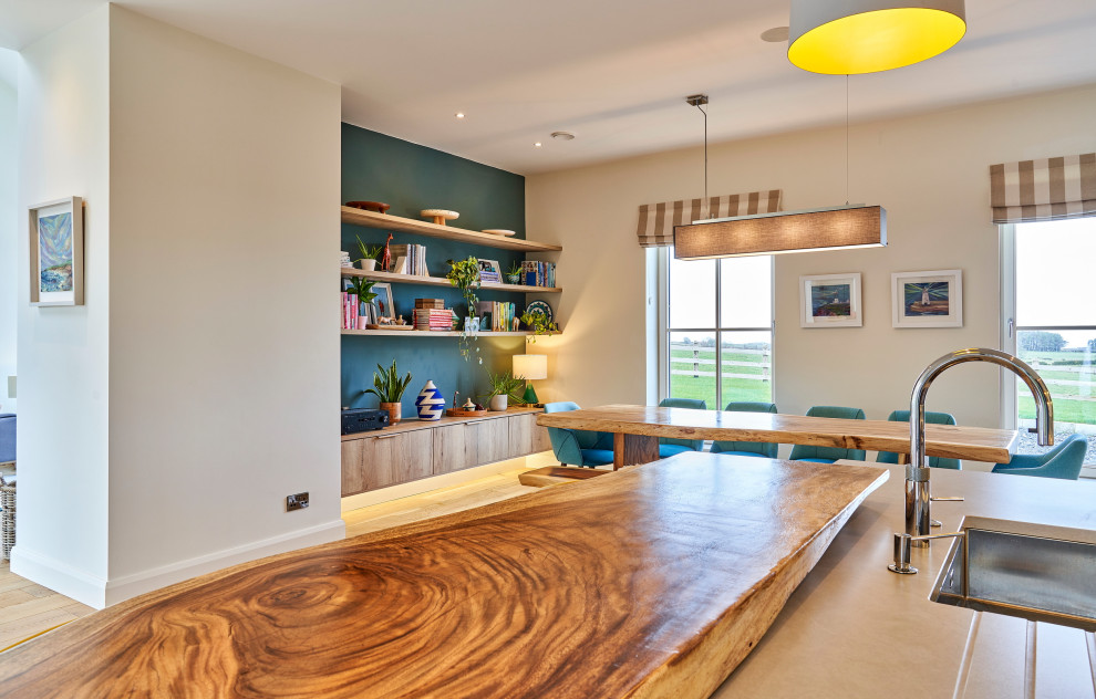 Photo of a large contemporary single-wall open plan kitchen in Other with a built-in sink, shaker cabinets, blue cabinets, quartz worktops, grey splashback, stone tiled splashback, white appliances, medium hardwood flooring, an island, brown floors and grey worktops.