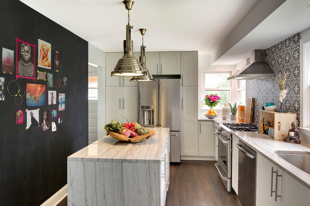Design ideas for a classic kitchen in Minneapolis with a submerged sink, shaker cabinets, white cabinets, multi-coloured splashback, ceramic splashback, stainless steel appliances, medium hardwood flooring, an island and a feature wall.