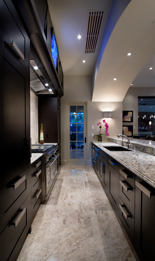 Enclosed kitchen - mid-sized contemporary galley travertine floor and gray floor enclosed kitchen idea in Miami with an undermount sink, shaker cabinets, brown cabinets, marble countertops, beige backsplash, travertine backsplash, stainless steel appliances and an island