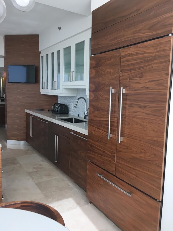Inspiration for a large modern galley marble floor and beige floor eat-in kitchen remodel in Miami with an undermount sink, flat-panel cabinets, dark wood cabinets, granite countertops, gray backsplash, mosaic tile backsplash, paneled appliances and an island
