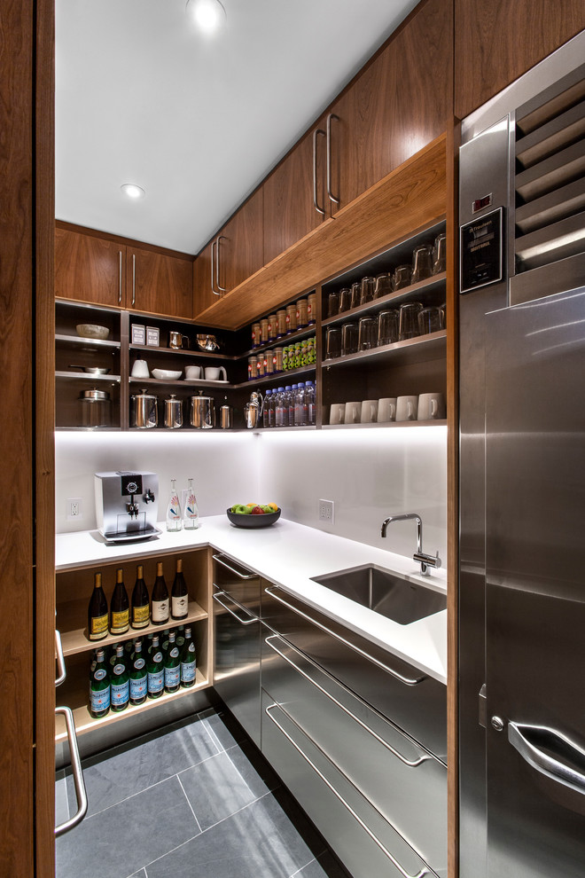Example of a trendy u-shaped gray floor kitchen pantry design in Toronto with an undermount sink, flat-panel cabinets, stainless steel cabinets, stainless steel appliances and no island
