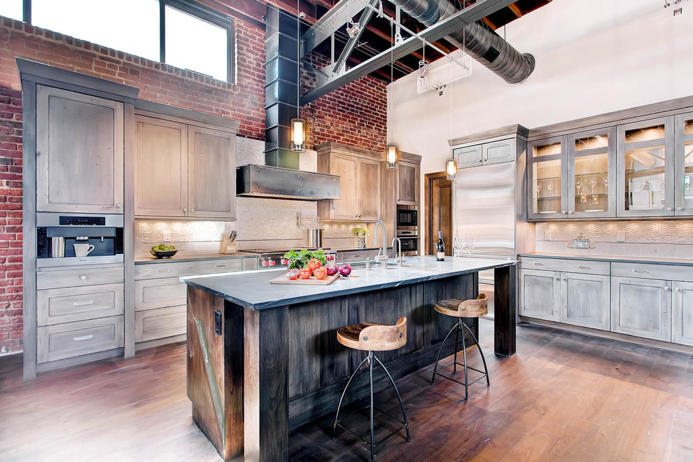 Inspiration for a huge contemporary l-shaped medium tone wood floor open concept kitchen remodel in Denver with an undermount sink, glass-front cabinets, distressed cabinets, granite countertops, metallic backsplash, glass tile backsplash, stainless steel appliances and an island