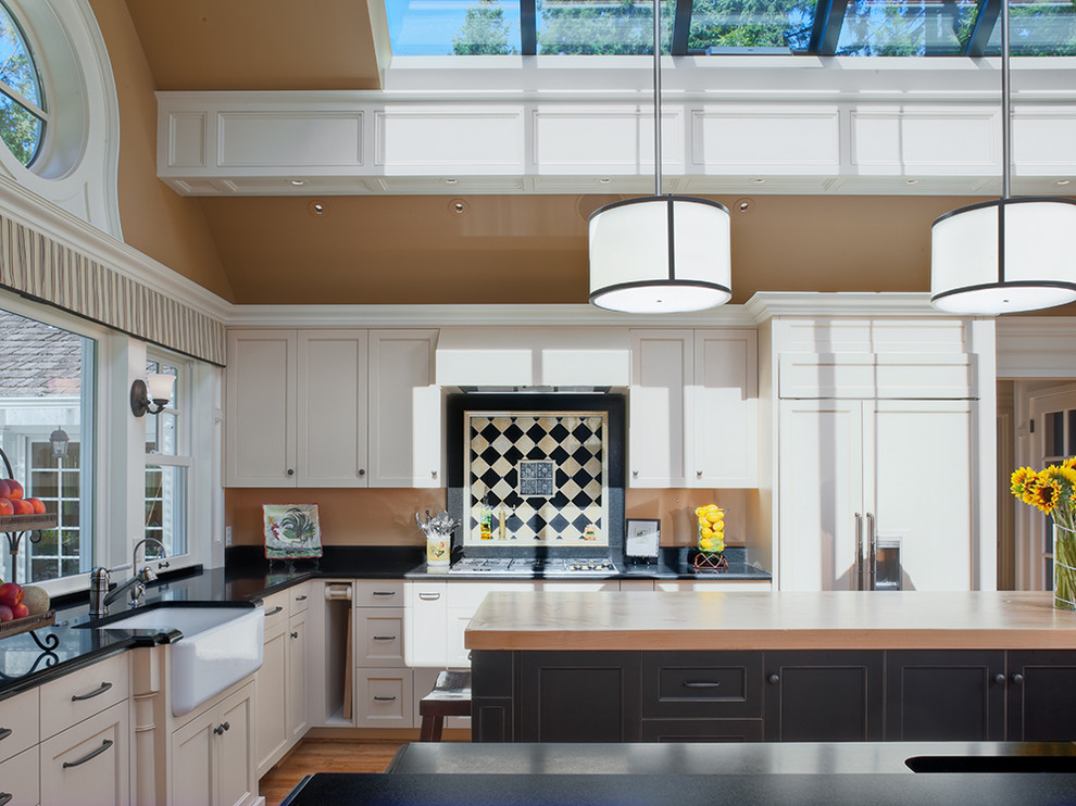 Design ideas for a traditional kitchen in Seattle with a belfast sink and wood worktops.