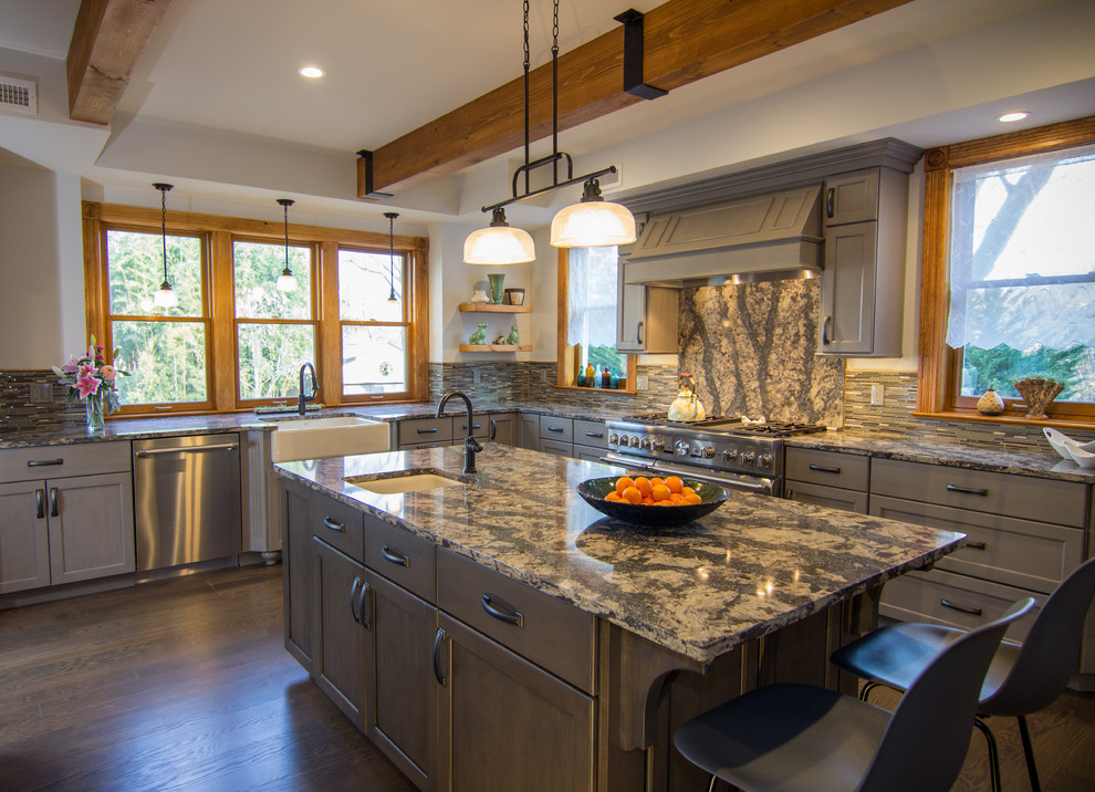 Inspiration for a large transitional l-shaped dark wood floor kitchen remodel in Charleston with a farmhouse sink, flat-panel cabinets, distressed cabinets, quartz countertops, multicolored backsplash, glass tile backsplash, stainless steel appliances and two islands
