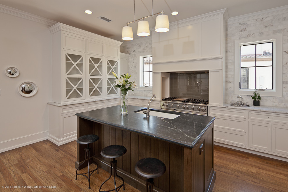 Inspiration for a transitional kitchen remodel in Austin with recessed-panel cabinets, soapstone countertops, white backsplash, stone tile backsplash, a single-bowl sink and white cabinets