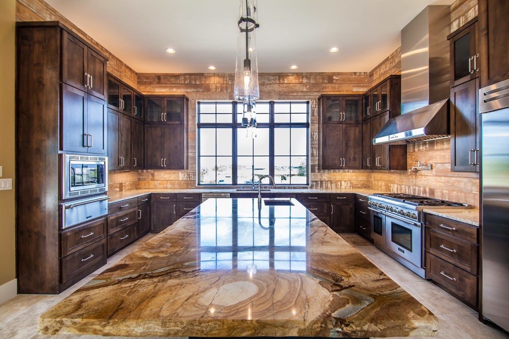 Kitchen pantry - large rustic u-shaped travertine floor kitchen pantry idea in Austin with an undermount sink, shaker cabinets, medium tone wood cabinets, granite countertops, brown backsplash, porcelain backsplash, stainless steel appliances and an island