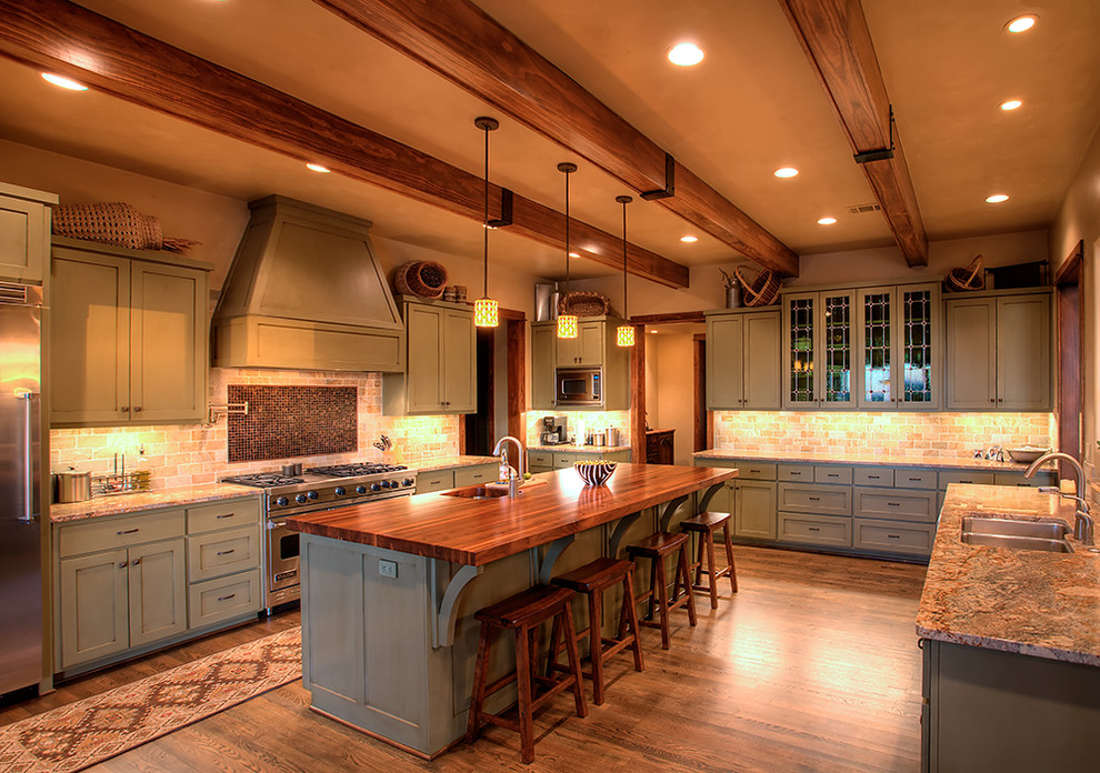 Example of a trendy kitchen design in Austin with shaker cabinets, green cabinets and stainless steel appliances