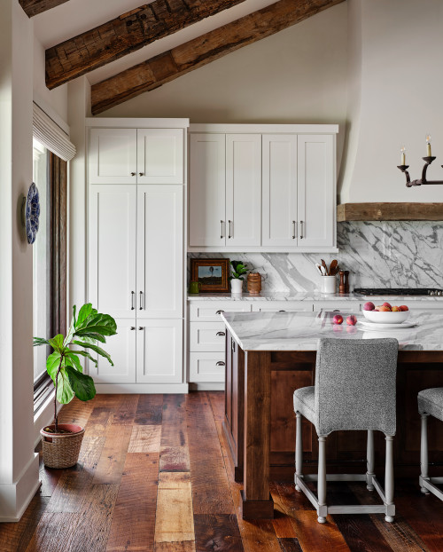 xposed beams, skylights, plastered range hood, and slab backsplash. Here you can see the lovely reclaimed wood floors. Walls and ceiling painted in Benjamin Moore "Wind's Breath".
Huge cottage single-wall medium tone wood floor and exposed beam kitchen photo in Austin with shaker cabinets, white cabinets, stainless steel appliances and an island