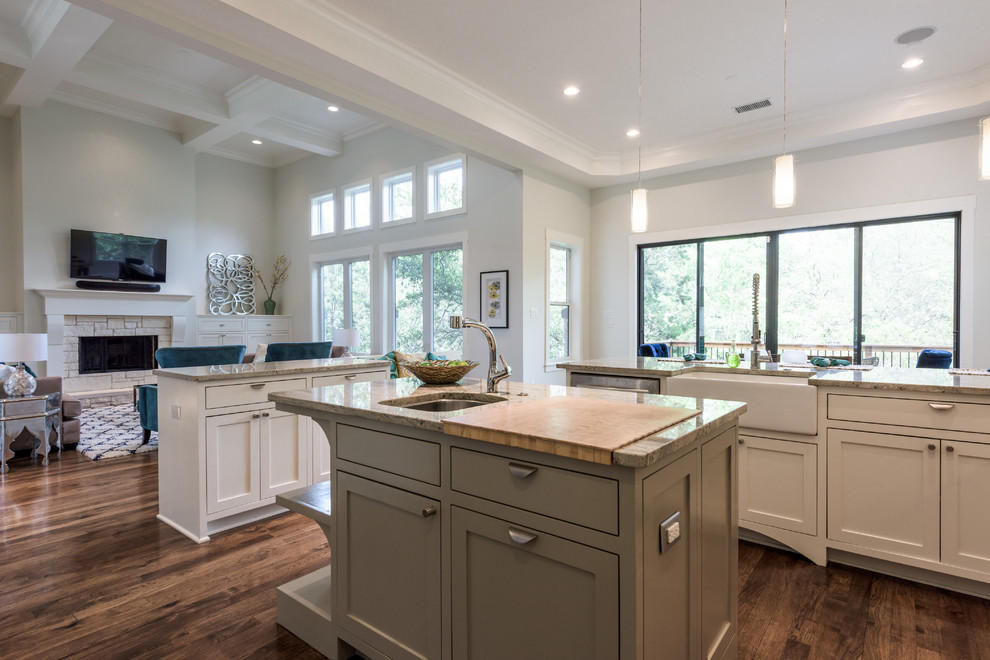 Inspiration for a large transitional u-shaped dark wood floor and brown floor eat-in kitchen remodel in Austin with a farmhouse sink, shaker cabinets, white cabinets, granite countertops, slate backsplash, stainless steel appliances, two islands and gray countertops