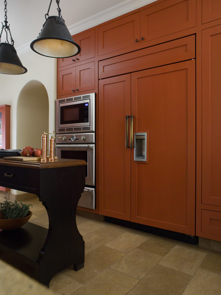 Photo of a medium sized mediterranean galley kitchen/diner in San Francisco with orange cabinets, recessed-panel cabinets, concrete worktops, multi-coloured splashback, stainless steel appliances, limestone flooring and an island.