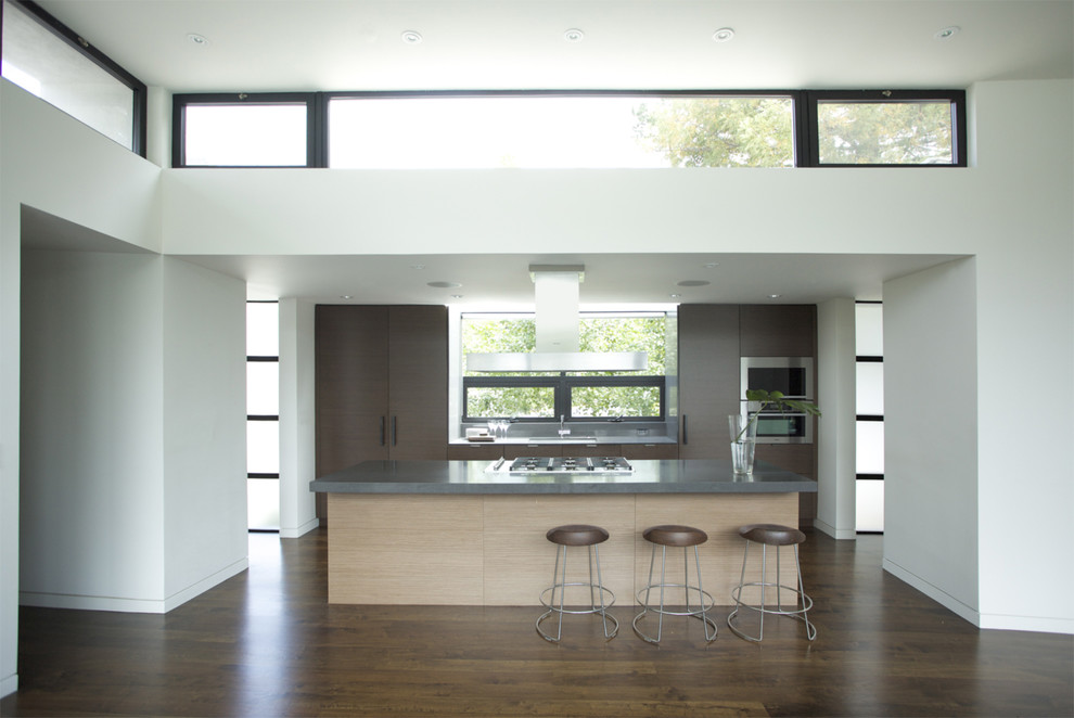 This is an example of a modern kitchen in San Francisco with stainless steel appliances and medium hardwood flooring.