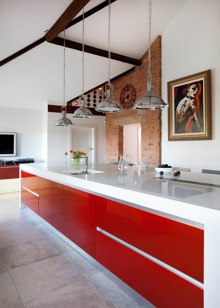 Inspiration for a large contemporary l-shaped enclosed kitchen in Belfast with a submerged sink, flat-panel cabinets, orange cabinets, composite countertops, white splashback, stone slab splashback, stainless steel appliances, ceramic flooring, an island and grey floors.