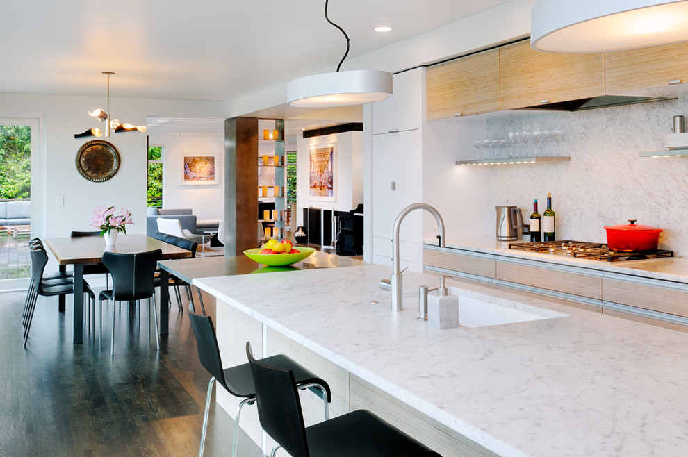 Eat-in kitchen - contemporary galley eat-in kitchen idea in Seattle with an undermount sink, flat-panel cabinets, light wood cabinets, marble countertops, white backsplash, stone slab backsplash and stainless steel appliances