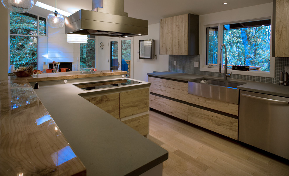 Inspiration for a large 1950s u-shaped light wood floor eat-in kitchen remodel in Other with a farmhouse sink, flat-panel cabinets, light wood cabinets, solid surface countertops, gray backsplash, mosaic tile backsplash, stainless steel appliances and a peninsula