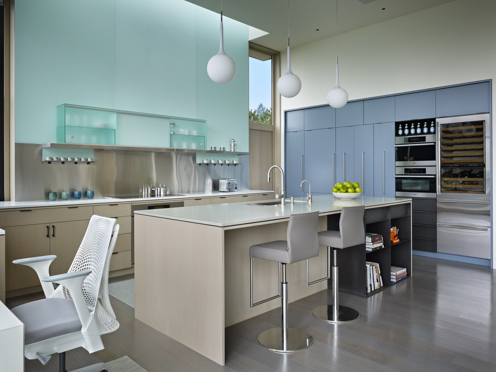 Design ideas for a modern l-shaped kitchen in Seattle with a submerged sink, flat-panel cabinets, blue cabinets, metallic splashback, metal splashback and stainless steel appliances.