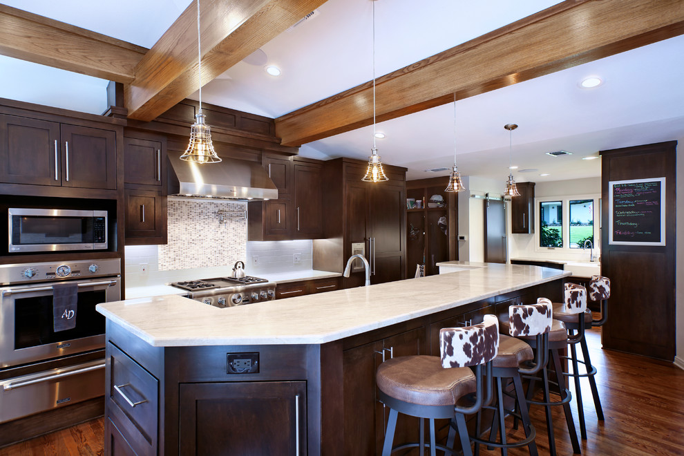 Mid-sized trendy single-wall medium tone wood floor open concept kitchen photo in Indianapolis with a farmhouse sink, shaker cabinets, dark wood cabinets, quartzite countertops, gray backsplash, mosaic tile backsplash, stainless steel appliances and an island