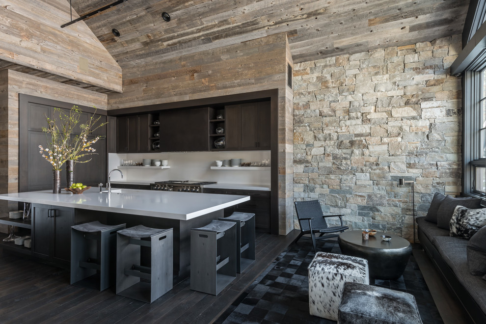 Open concept kitchen - rustic dark wood floor open concept kitchen idea in Other with a single-bowl sink, dark wood cabinets, white backsplash, paneled appliances and an island