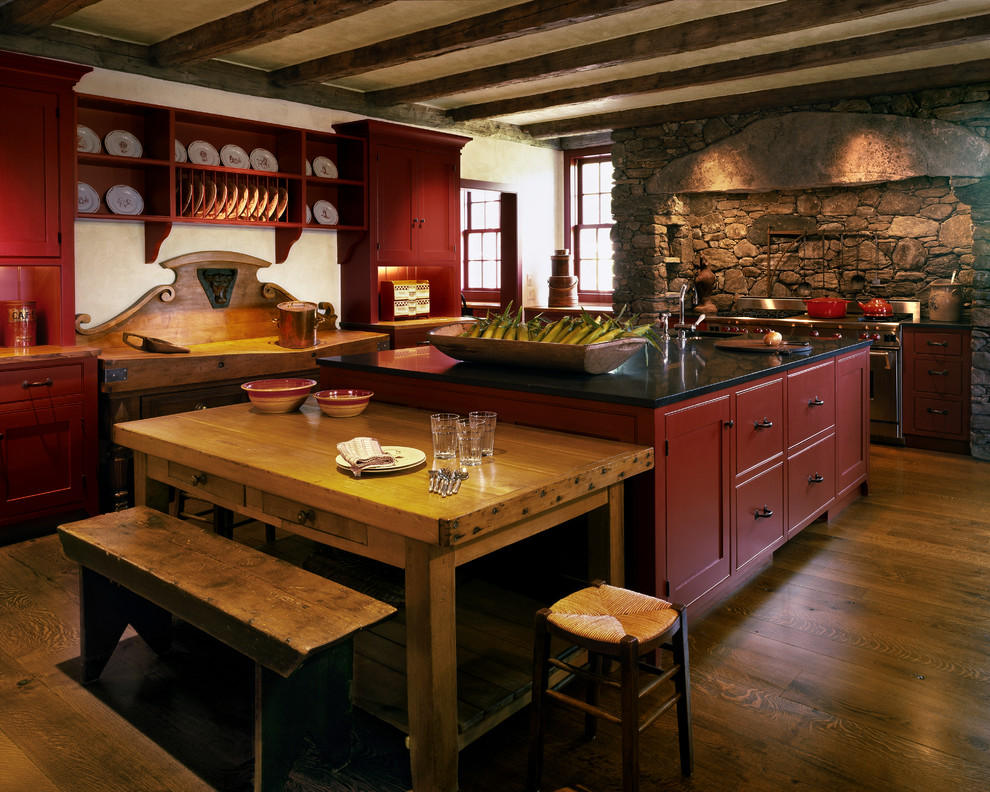 Example of a large medium tone wood floor eat-in kitchen design in New York with an undermount sink, shaker cabinets, red cabinets, granite countertops, red backsplash, stainless steel appliances and an island