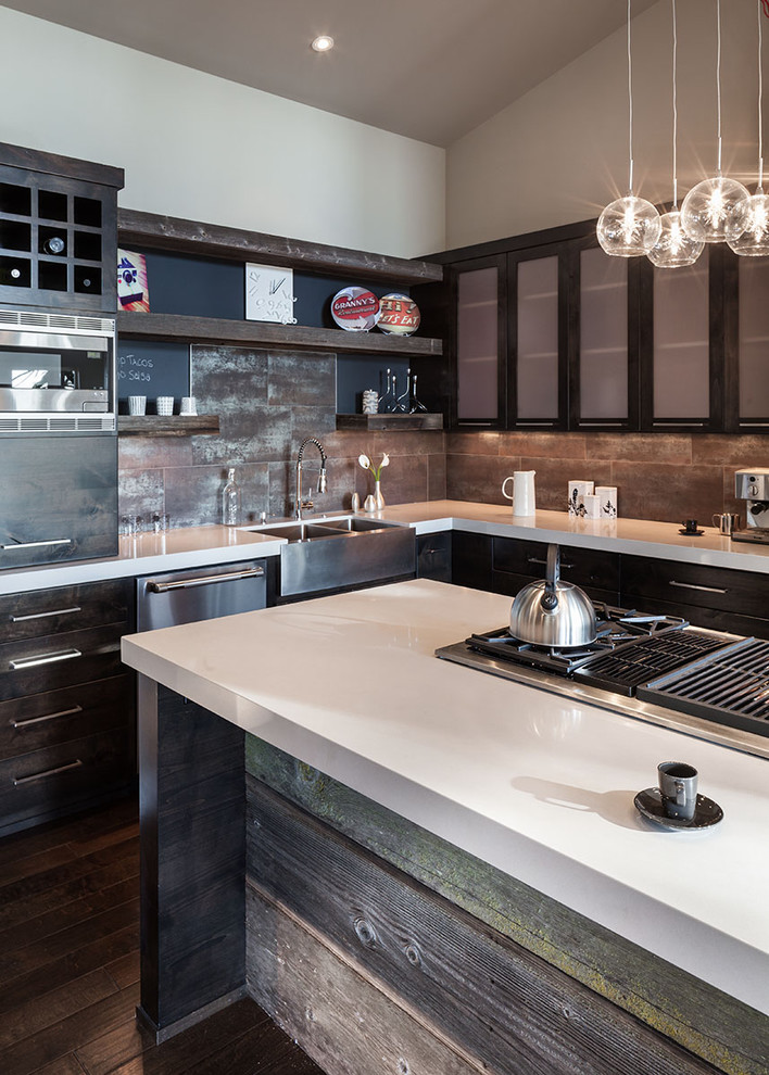 Inspiration for a large contemporary l-shaped dark wood floor eat-in kitchen remodel in Portland with stainless steel appliances, a farmhouse sink, quartz countertops, flat-panel cabinets, dark wood cabinets, metallic backsplash, porcelain backsplash and an island