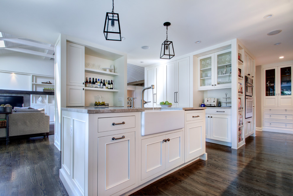 Example of a classic open concept kitchen design in Chicago with a farmhouse sink, recessed-panel cabinets, white cabinets and stainless steel appliances