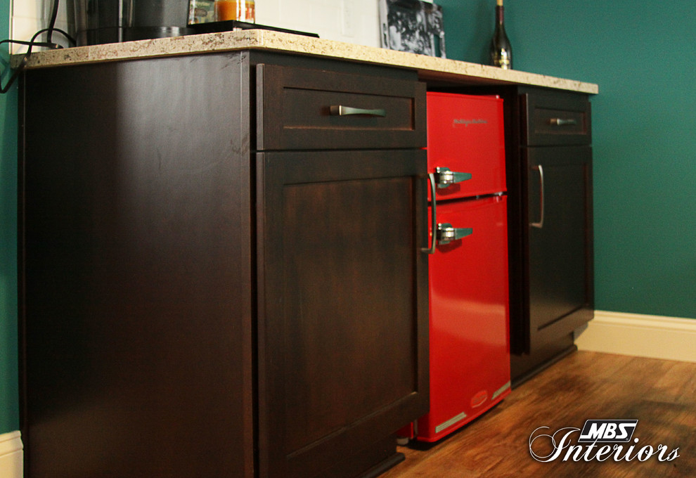 Eat-in kitchen - mid-sized eclectic l-shaped medium tone wood floor and brown floor eat-in kitchen idea in Detroit with a farmhouse sink, shaker cabinets, brown cabinets, quartz countertops, white backsplash, subway tile backsplash, stainless steel appliances and an island