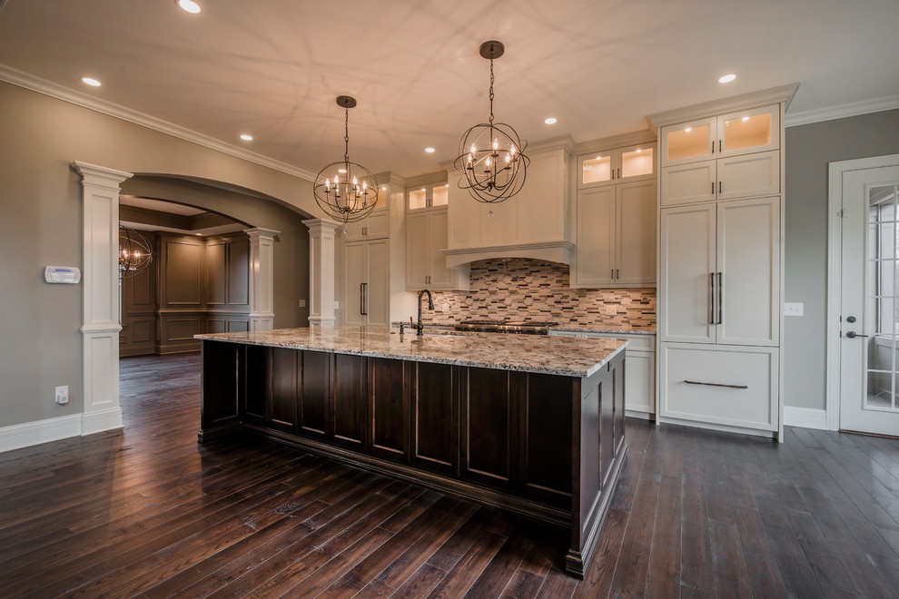 Large elegant dark wood floor and brown floor kitchen photo in Columbus with an undermount sink, flat-panel cabinets, white cabinets, granite countertops, stone tile backsplash, paneled appliances and an island