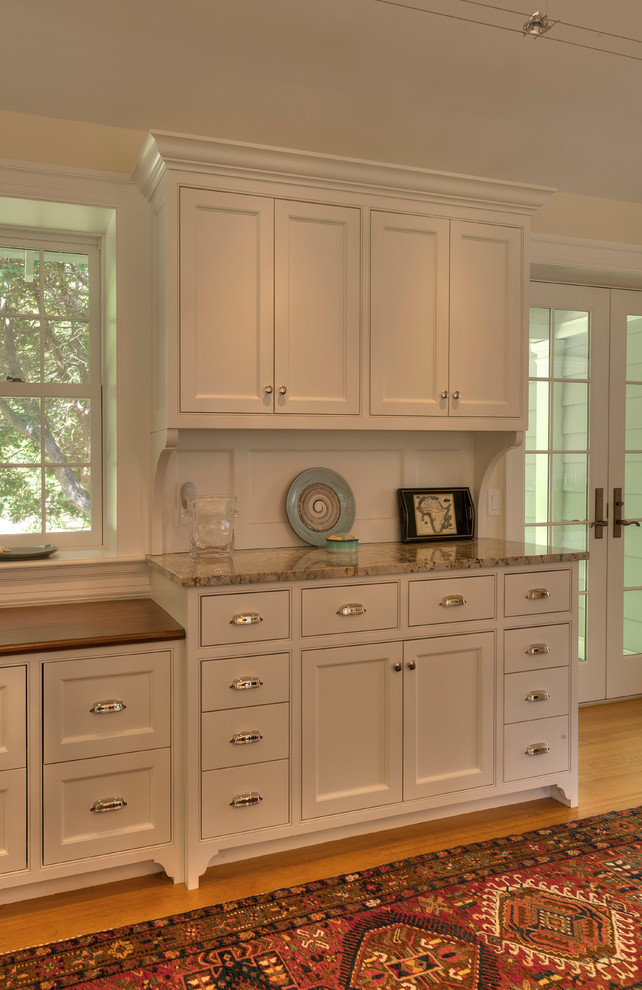 Inspiration for a traditional kitchen in Burlington with a submerged sink, recessed-panel cabinets, white cabinets, granite worktops, stainless steel appliances and an island.