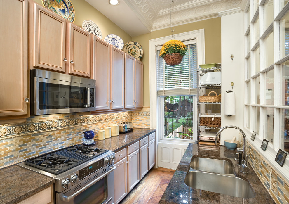 Photo of a small traditional galley enclosed kitchen in New York with a double-bowl sink.