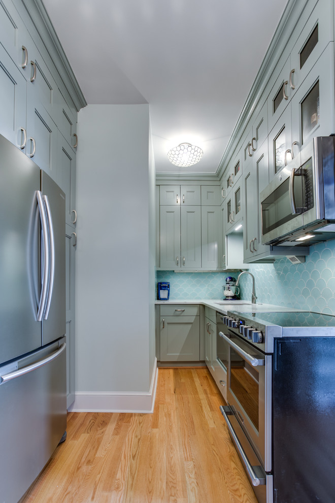 Small elegant light wood floor eat-in kitchen photo in DC Metro with a single-bowl sink, shaker cabinets, blue cabinets, quartz countertops, blue backsplash, ceramic backsplash, stainless steel appliances and no island