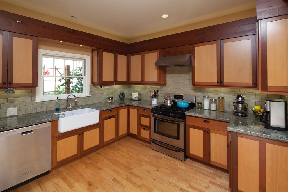 Eat-in kitchen - small craftsman u-shaped eat-in kitchen idea in San Luis Obispo with a farmhouse sink, shaker cabinets, light wood cabinets, granite countertops, green backsplash, ceramic backsplash, stainless steel appliances and no island