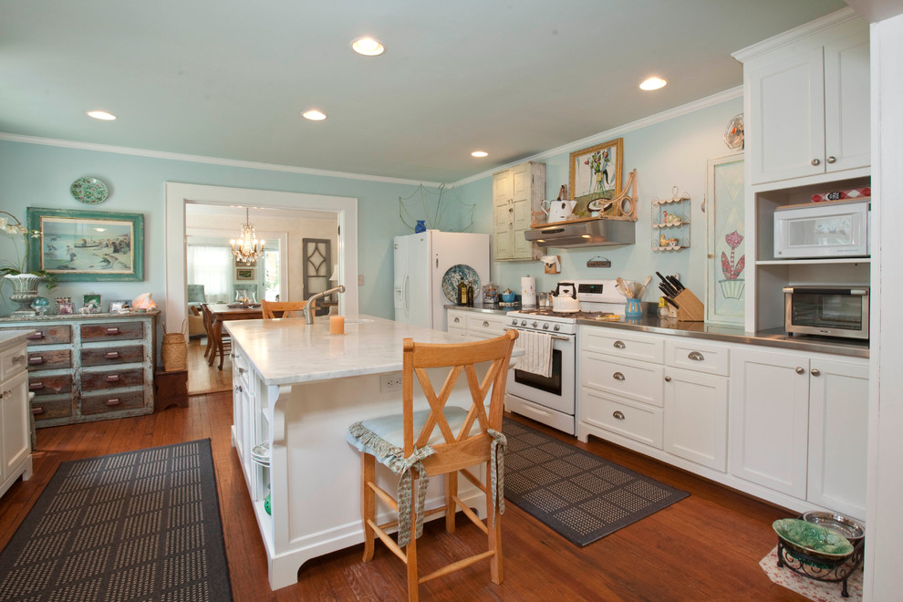 Photo of a traditional galley kitchen in Wilmington with recessed-panel cabinets, white cabinets and white appliances.