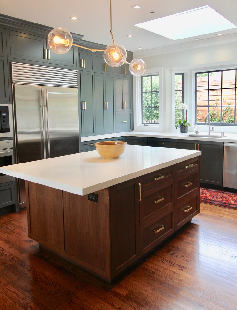 Design ideas for a medium sized traditional u-shaped enclosed kitchen in San Francisco with a single-bowl sink, shaker cabinets, grey cabinets, quartz worktops, stainless steel appliances, dark hardwood flooring, an island and brown floors.