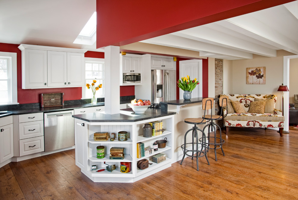 Example of a large farmhouse l-shaped medium tone wood floor open concept kitchen design in Philadelphia with a double-bowl sink, raised-panel cabinets, white cabinets, granite countertops, gray backsplash, stone slab backsplash, stainless steel appliances and an island