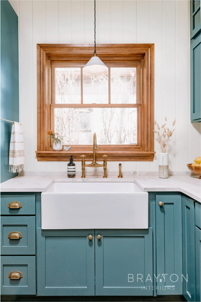 Example of an arts and crafts kitchen design in Denver with shaker cabinets, green cabinets, marble countertops, white backsplash, wood backsplash and white countertops