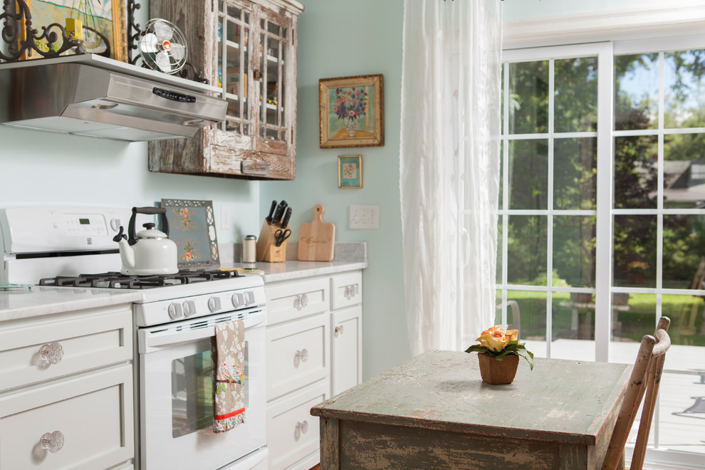 Cottage chic enclosed kitchen photo in Wilmington with white cabinets, marble countertops and white appliances