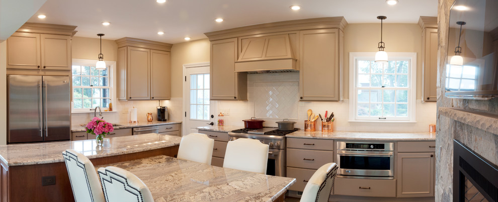 Large elegant l-shaped ceramic tile eat-in kitchen photo in DC Metro with an undermount sink, raised-panel cabinets, beige cabinets, granite countertops, white backsplash, subway tile backsplash, stainless steel appliances and an island