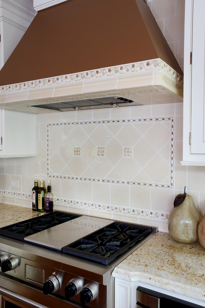 Immagine di una cucina chic di medie dimensioni con ante a filo, ante bianche, top in granito, paraspruzzi con piastrelle in ceramica e elettrodomestici in acciaio inossidabile