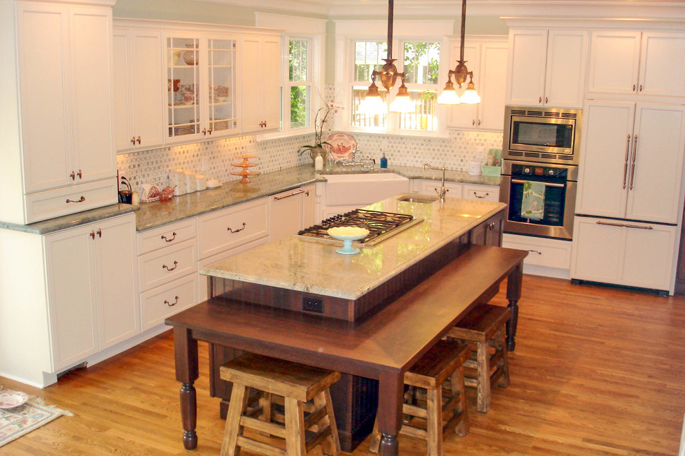 Inspiration for a timeless l-shaped eat-in kitchen remodel in Cincinnati with a farmhouse sink, recessed-panel cabinets, white cabinets, granite countertops and paneled appliances