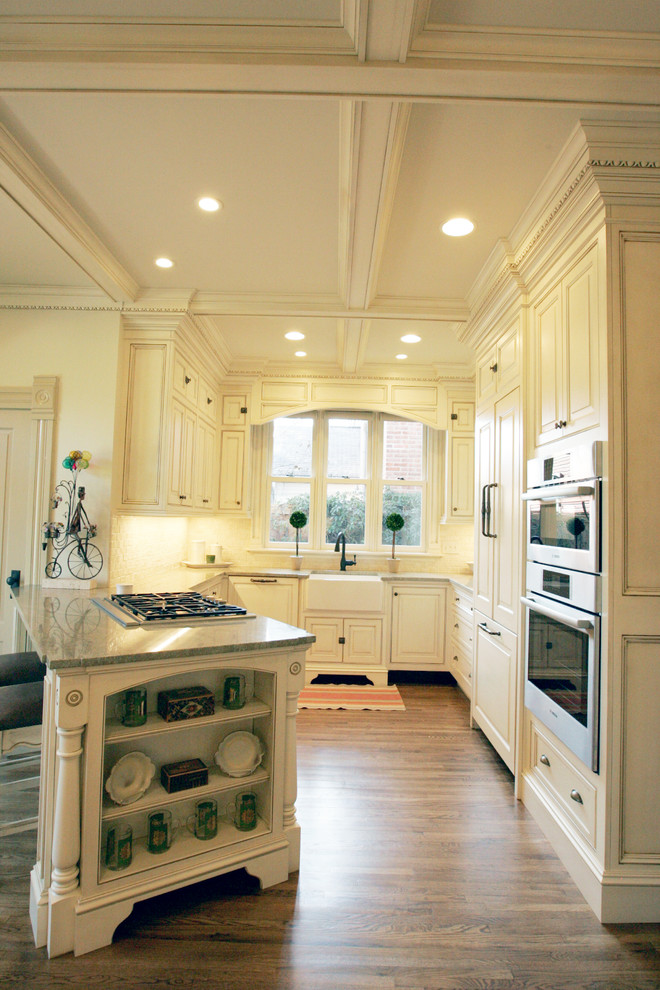This is an example of a large traditional kitchen in Columbus with raised-panel cabinets.