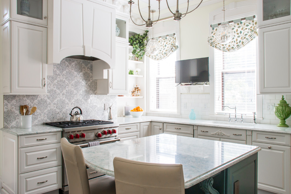 Kitchen - traditional l-shaped kitchen idea in New York with an undermount sink, raised-panel cabinets, white cabinets, multicolored backsplash, stainless steel appliances, an island and multicolored countertops