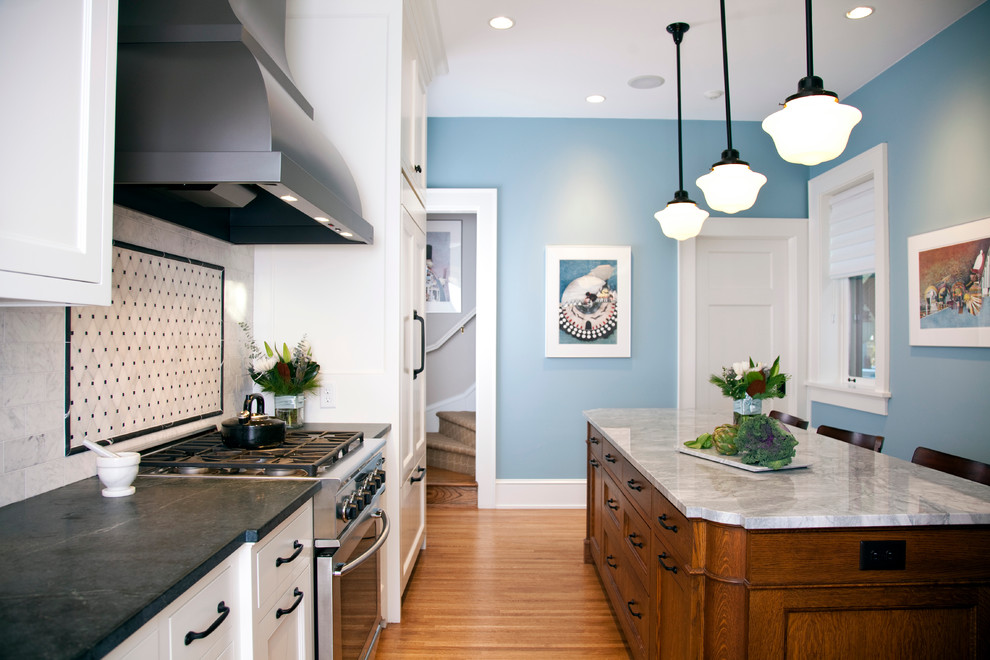 Elegant kitchen photo in Minneapolis with soapstone countertops, shaker cabinets, white cabinets, multicolored backsplash and stainless steel appliances