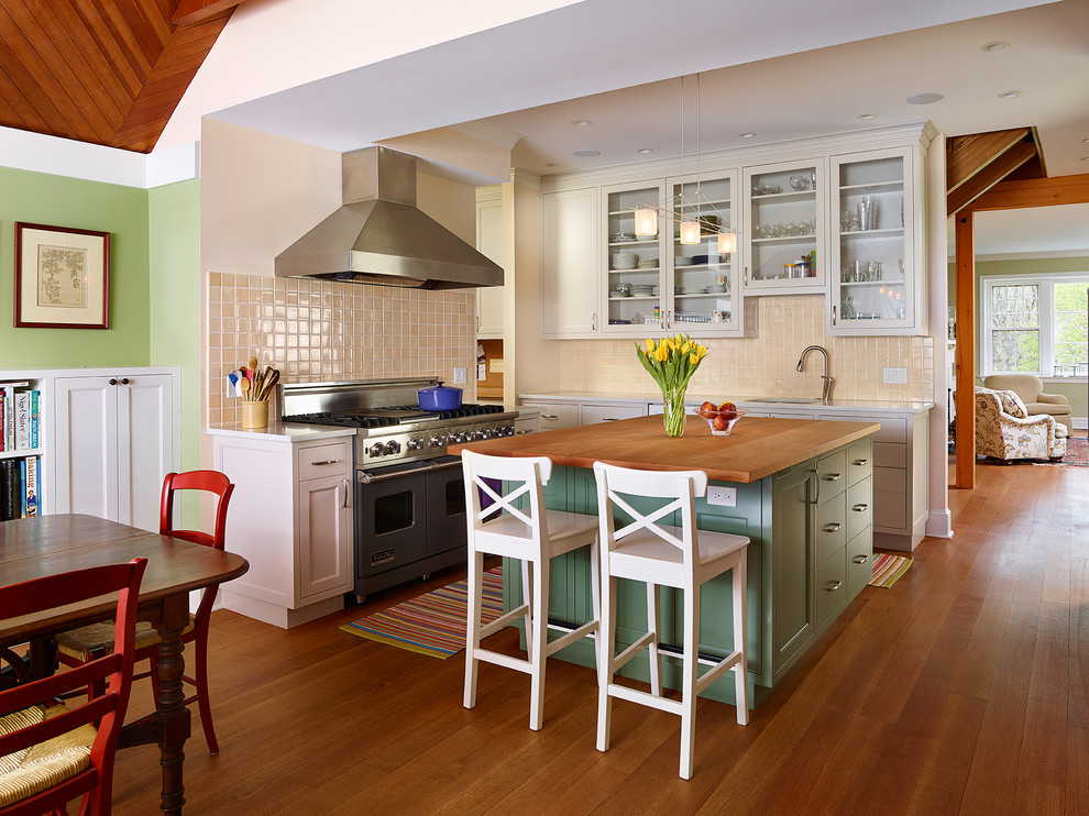 Exempel på ett stort lantligt kök, med en undermonterad diskho, luckor med glaspanel, beige skåp, marmorbänkskiva, beige stänkskydd, stänkskydd i keramik, färgglada vitvaror, mellanmörkt trägolv och en köksö