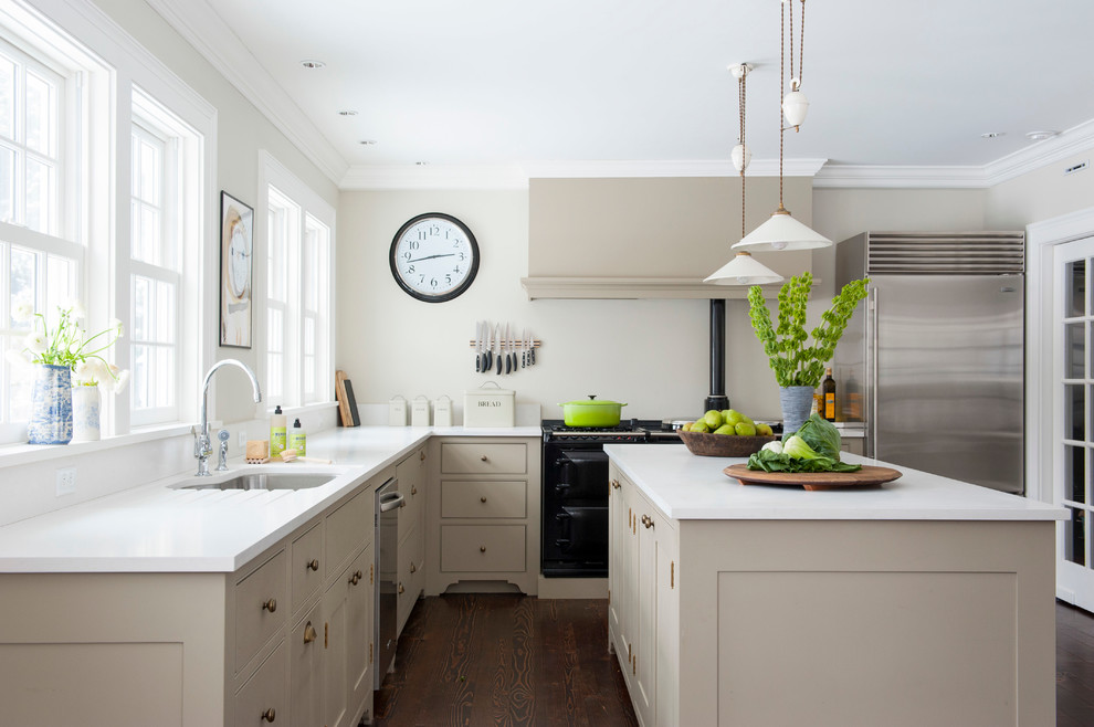 Example of a transitional l-shaped enclosed kitchen design in Bridgeport with shaker cabinets, beige cabinets and stainless steel appliances