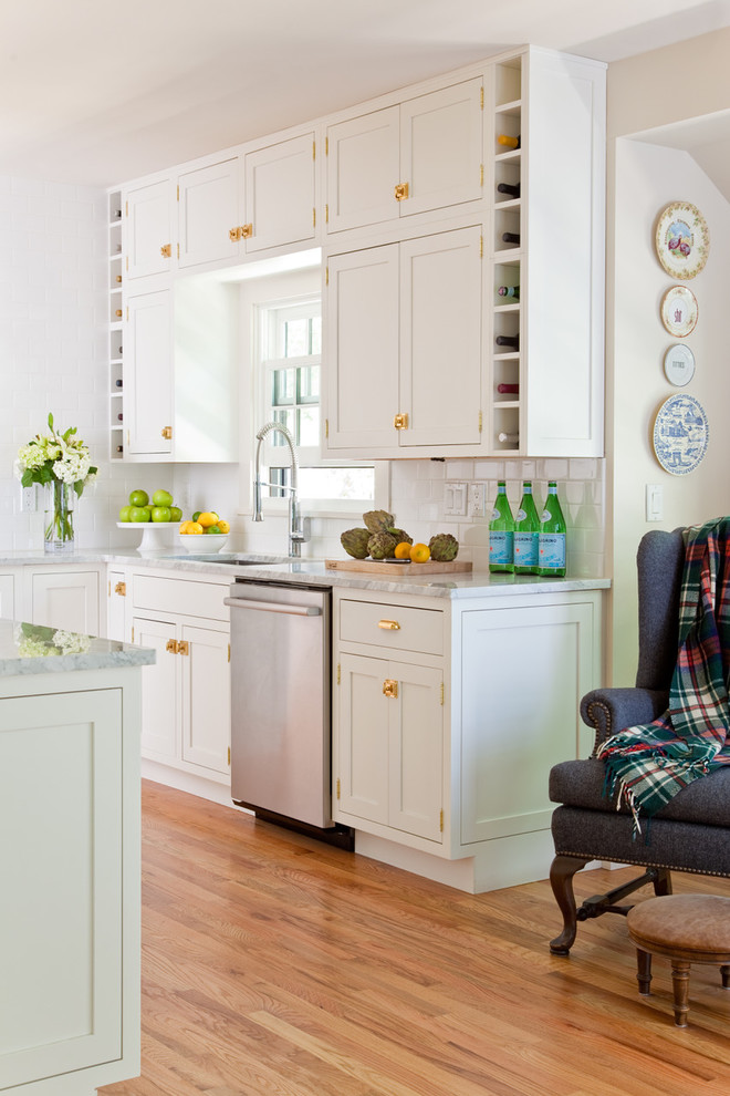 Inspiration for a farmhouse medium tone wood floor and brown floor kitchen remodel in Other with an undermount sink, shaker cabinets, white cabinets and stainless steel appliances