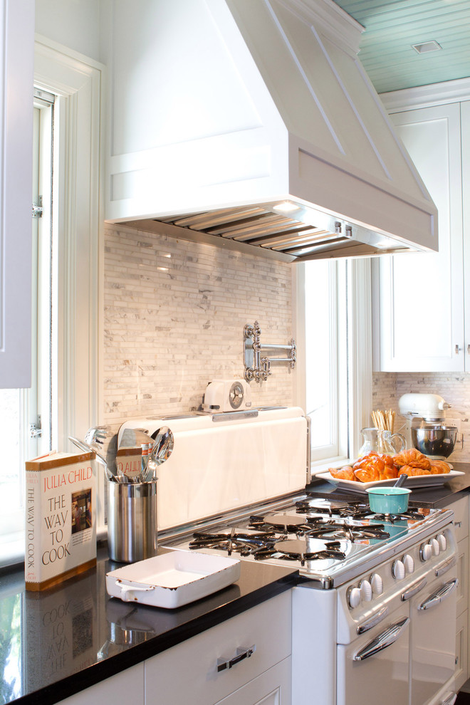 Inspiration for a timeless kitchen remodel in Los Angeles with white cabinets, white backsplash, white appliances and marble backsplash