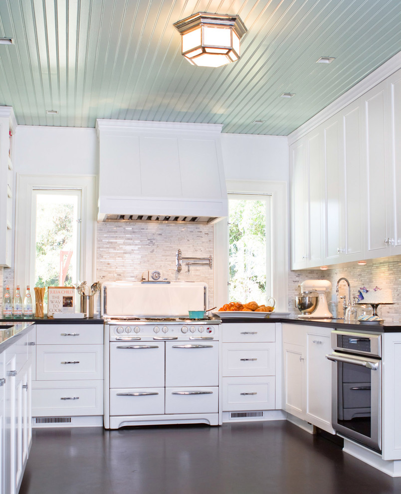 Inspiration for a timeless u-shaped kitchen remodel in Los Angeles with recessed-panel cabinets, white appliances and white cabinets
