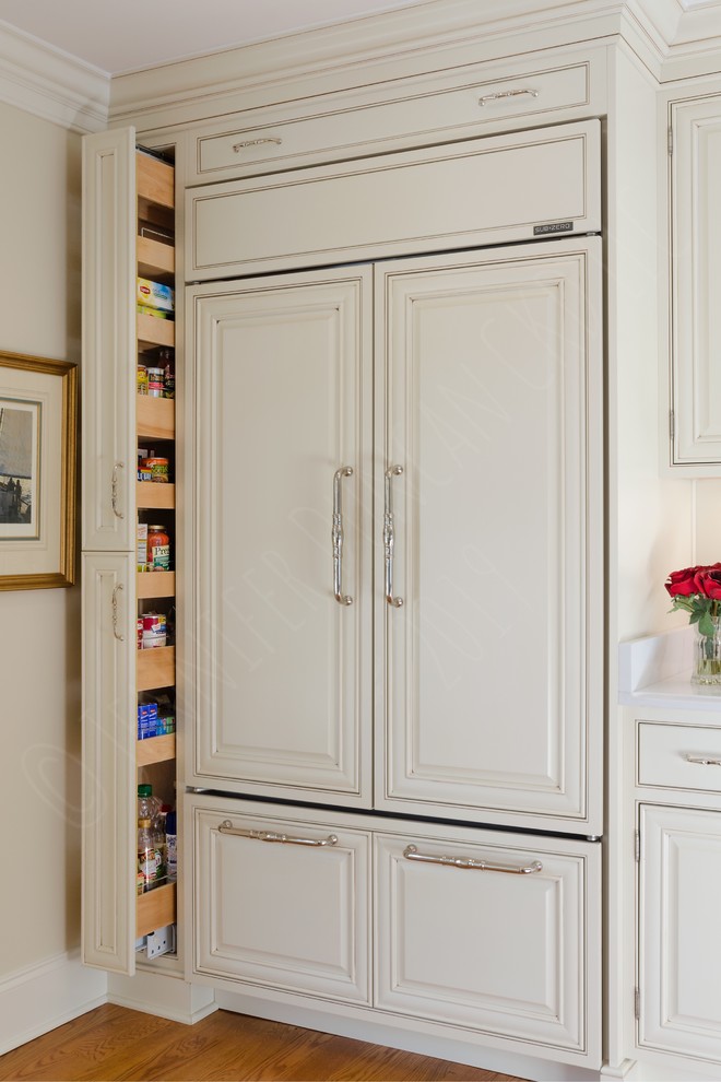 Design ideas for a large classic galley kitchen pantry in Richmond with a submerged sink, beaded cabinets, white cabinets, engineered stone countertops, beige splashback, integrated appliances, medium hardwood flooring, an island, brown floors and white worktops.